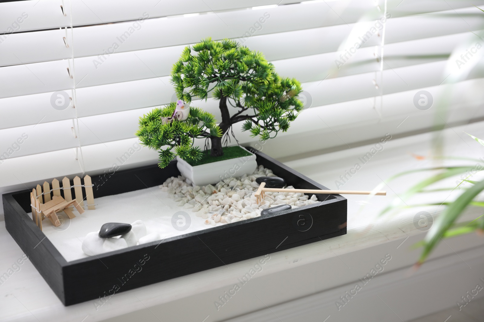 Photo of Beautiful miniature zen garden on window sill