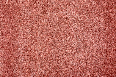 Soft coral color carpet as background, top view