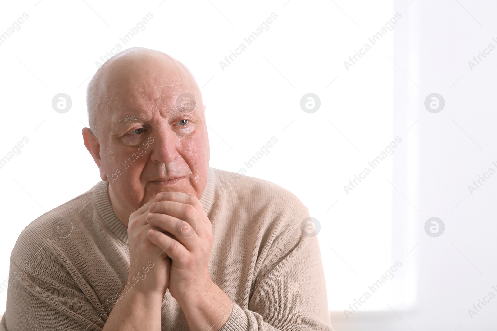 Photo of Senior man in state of depression indoors