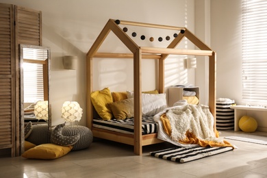 Cozy child room interior with comfortable bed