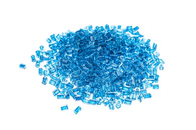 Pile of light blue beads on white background