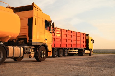 Modern bright trucks parked on country road