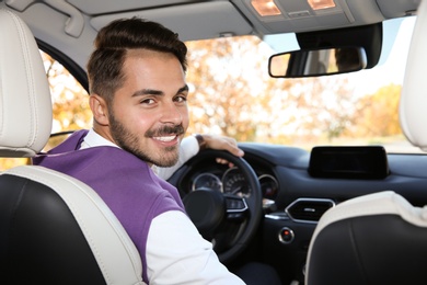 Young man in driver's seat of modern car