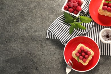 Pieces of delicious Napoleon cake with fresh raspberries served on grey table, flat lay. Space for text