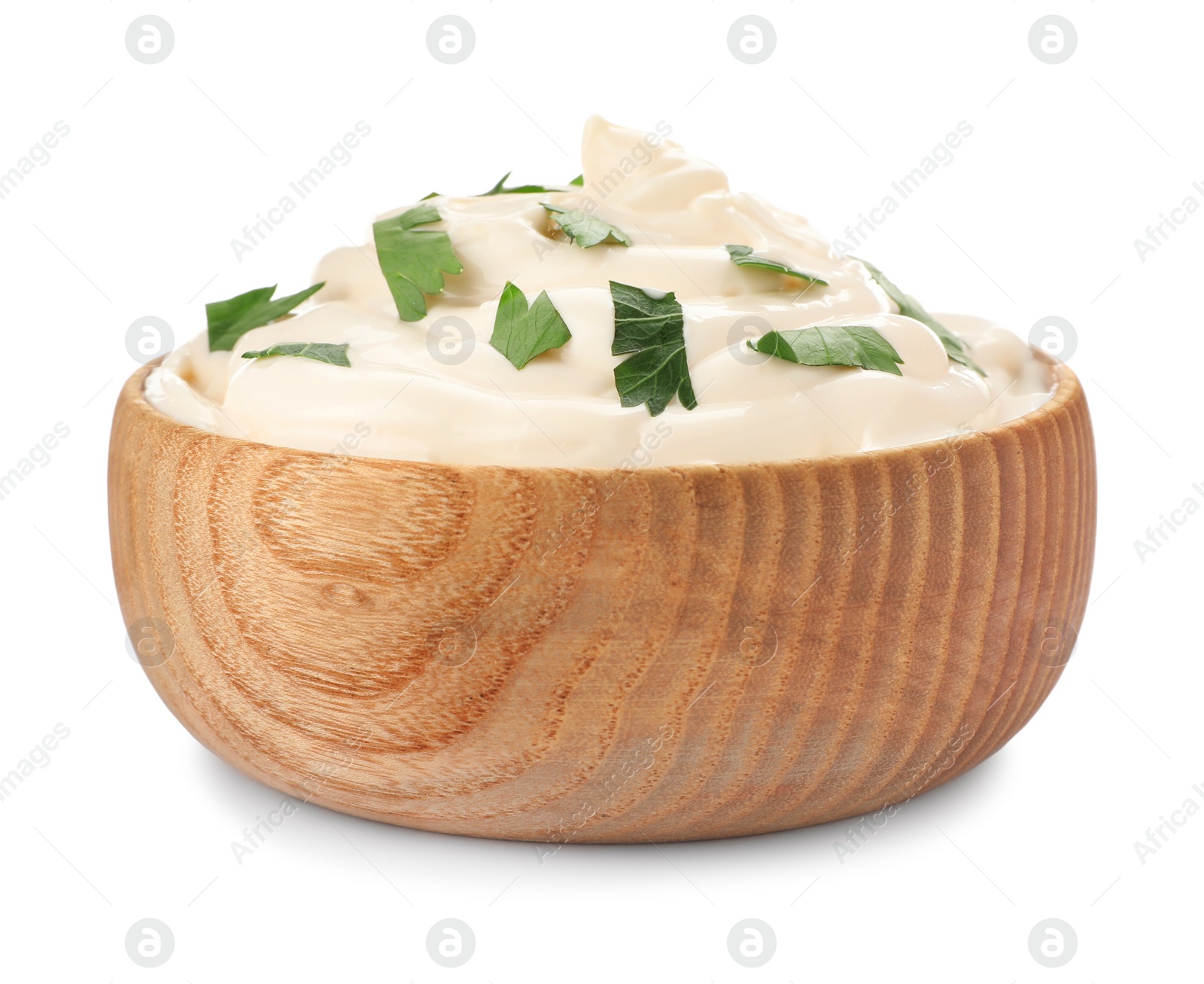 Photo of Mayonnaise with parsley in wooden bowl isolated on white