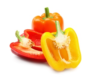 Whole and cut ripe bell peppers on white background