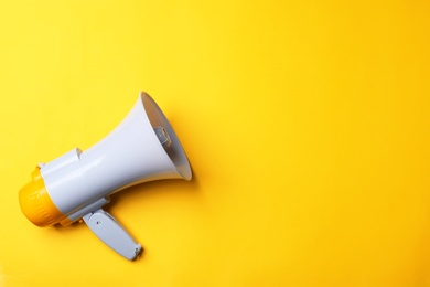 Photo of Electronic megaphone on color background