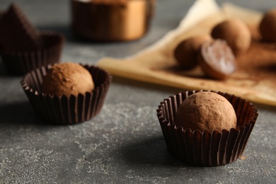 Photo of Tasty chocolate truffles on grey background, closeup