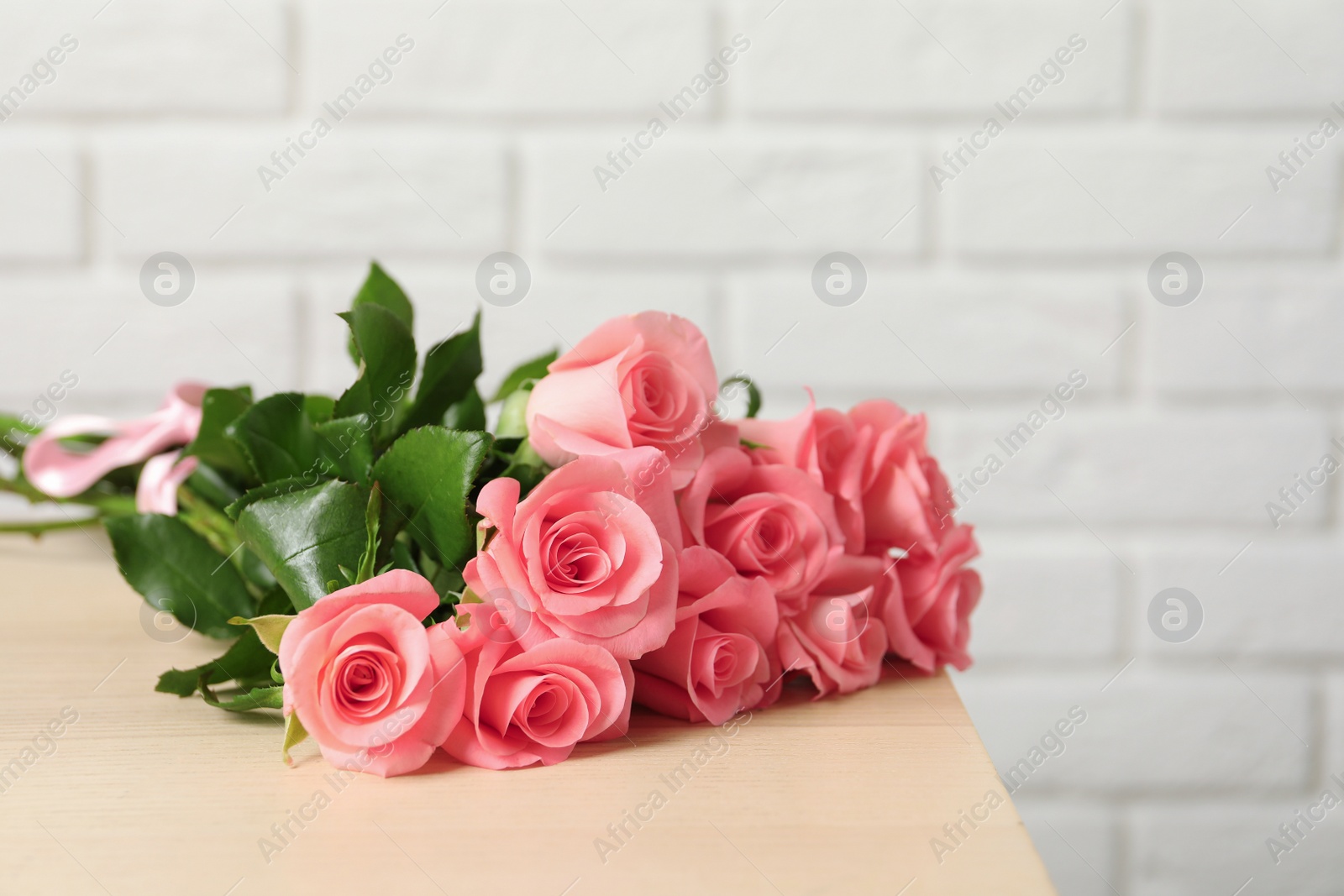 Photo of Bouquet of beautiful roses on table