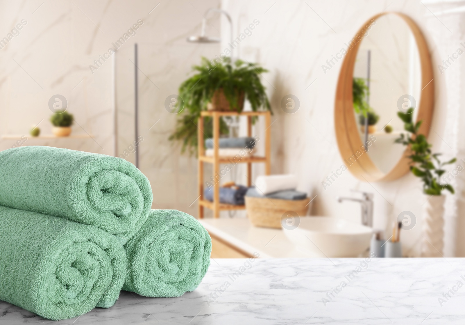 Image of Fresh towels on marble table in bathroom. Space for text