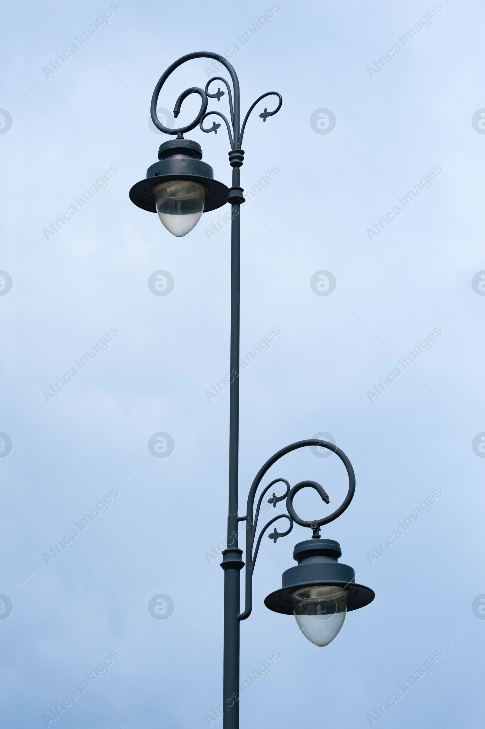 Photo of Beautiful vintage street lamp against cloudy sky