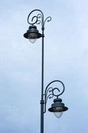 Beautiful vintage street lamp against cloudy sky