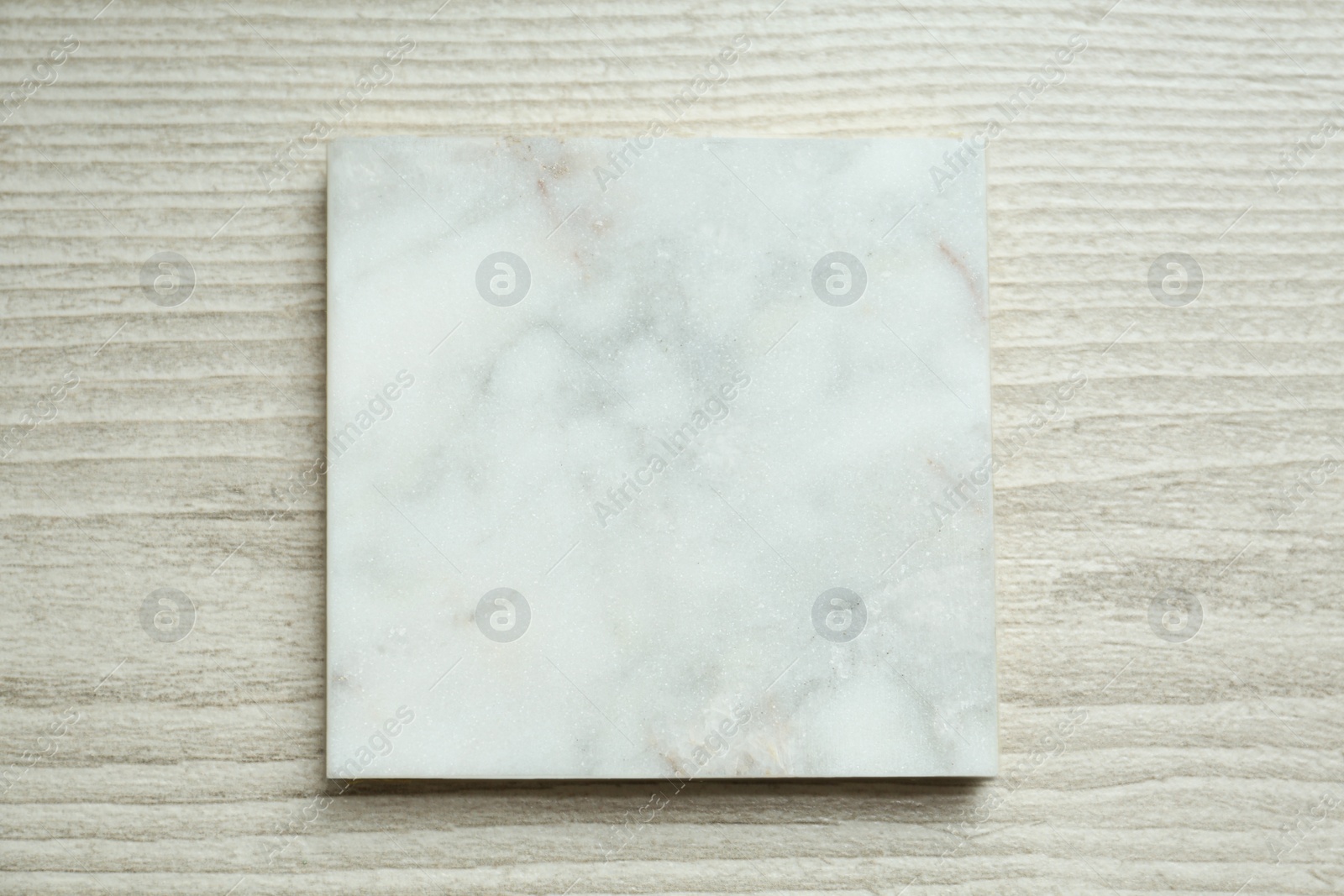 Photo of Marble board on wooden table, top view