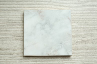 Photo of Marble board on wooden table, top view