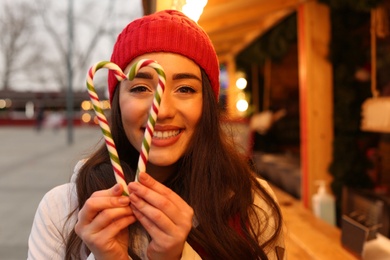 Photo of Young woman spending time at Christmas fair