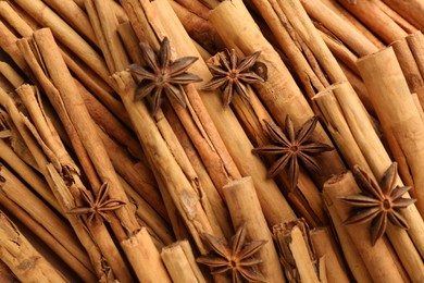 Aromatic cinnamon sticks and anise as background, top view