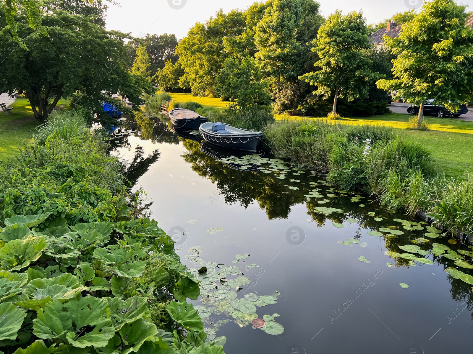 Photo of Beautiful view of moored boats in canal on sunny day