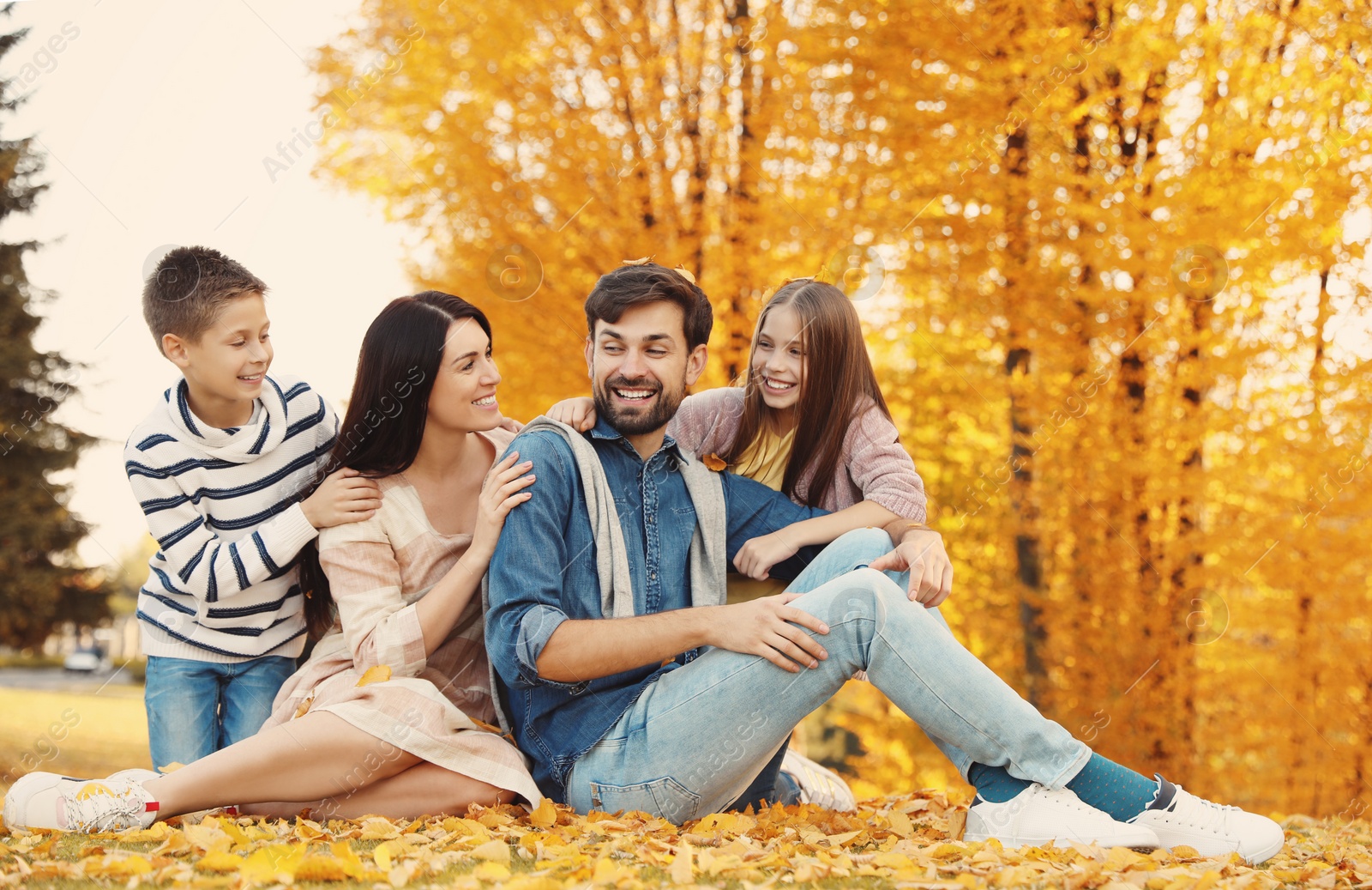 Photo of Happy family with children spending time in park. Autumn walk