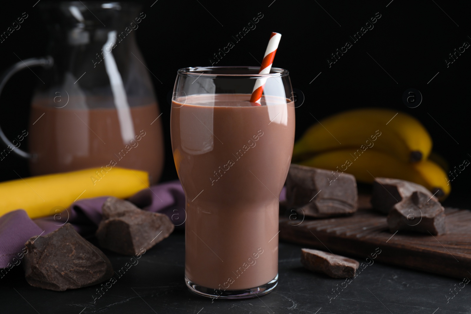 Photo of Fresh yummy chocolate milk on black table