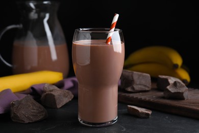 Fresh yummy chocolate milk on black table