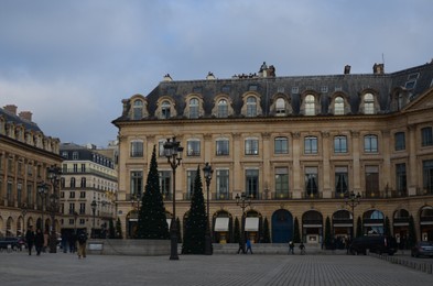 Paris, France - December 10, 2022: Cityscape with beautiful buildings and Christmas trees