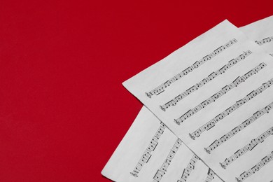 Photo of Note sheets on red background, space for text