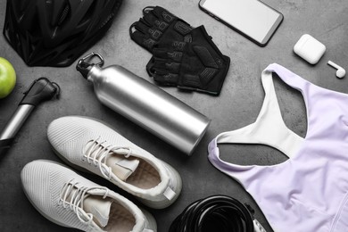 Photo of Flat lay composition with different cycling accessories on grey background