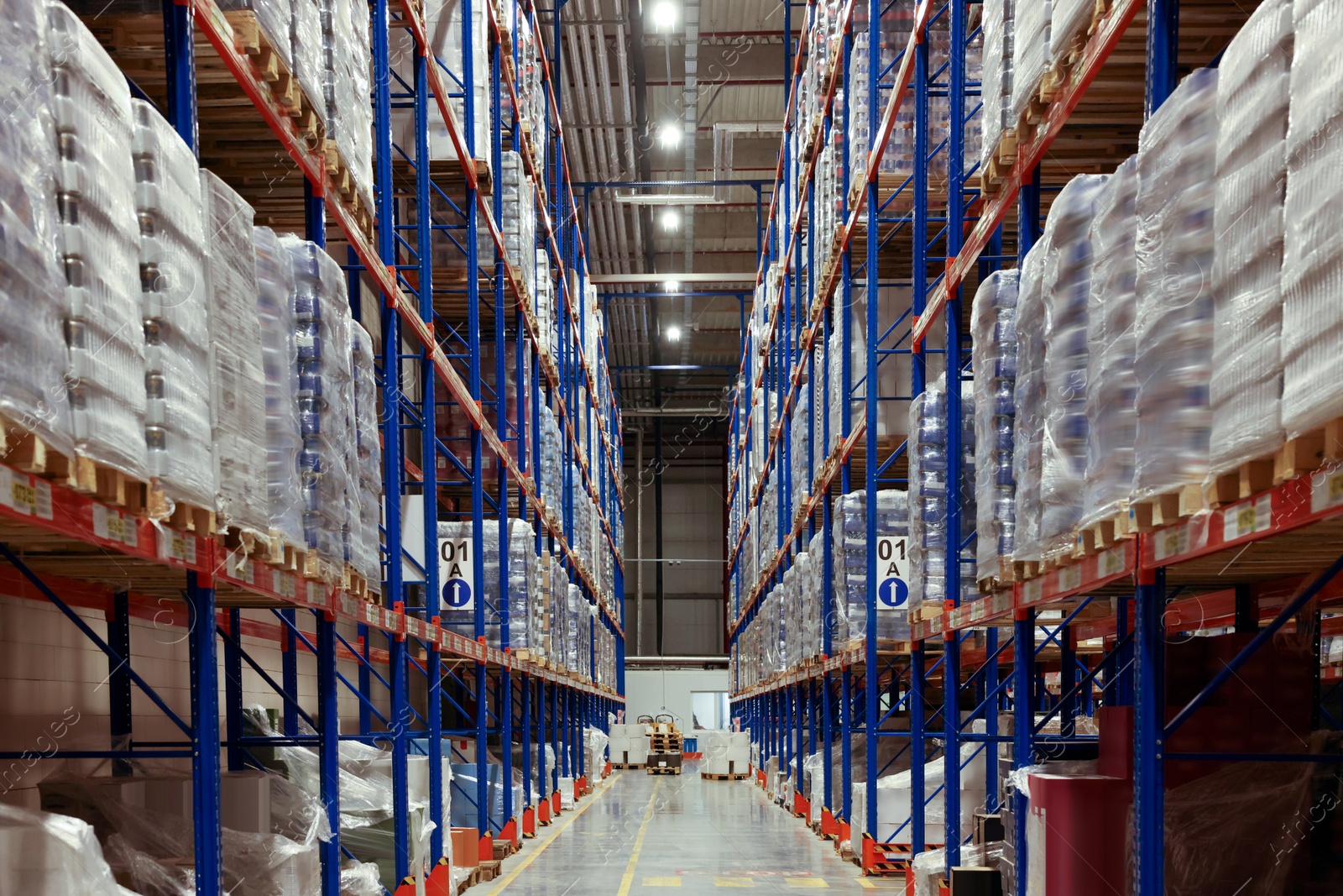 Photo of Warehouse interior with metal racks full of merchandise. Wholesale business