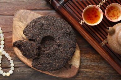 Photo of Flat lay composition with pu-erh tea on wooden table