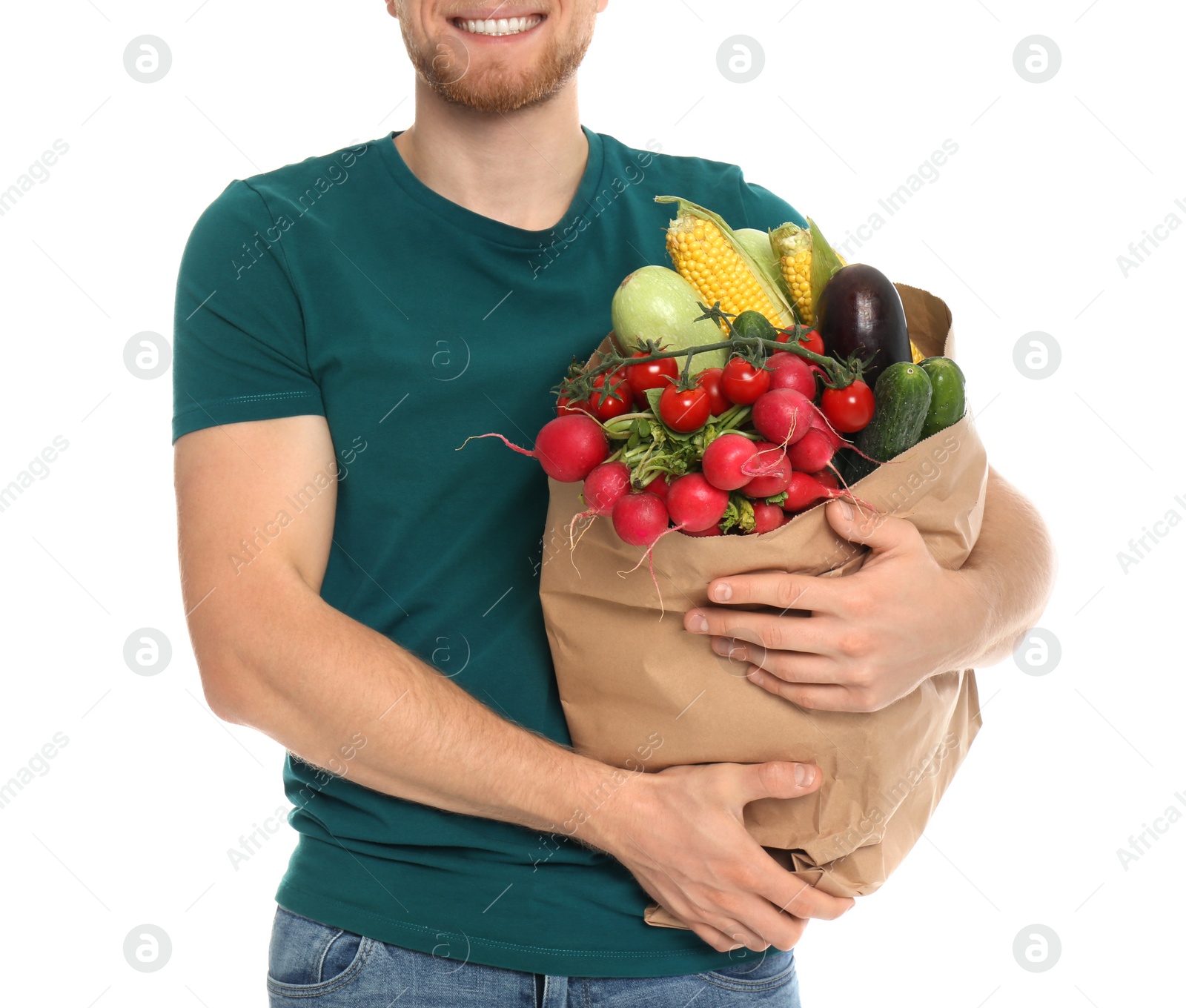 Photo of Young man with bag of fresh vegetables on white background, closeup