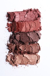 Different crushed eye shadows on white background, top view. Professional makeup product