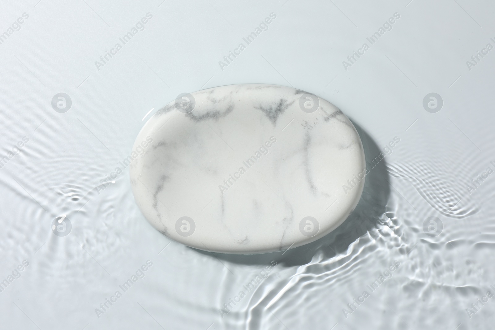 Photo of Presentation for product. Marble podium in water on white background, top view