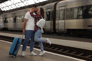 Photo of Long-distance relationship. Beautiful couple kissing on platform of railway station