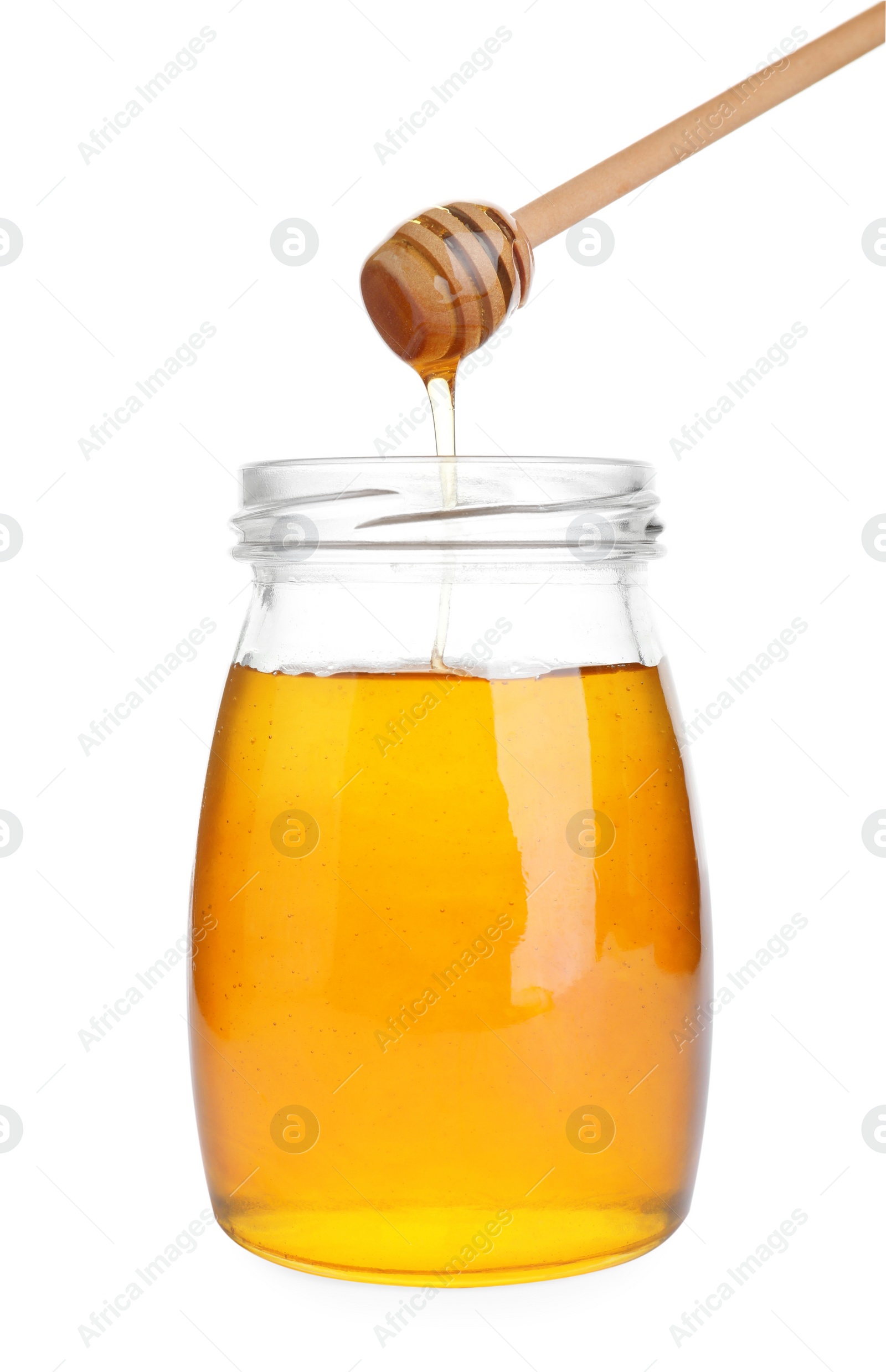 Photo of Glass jar of sunflower honey and wooden dipper isolated on white