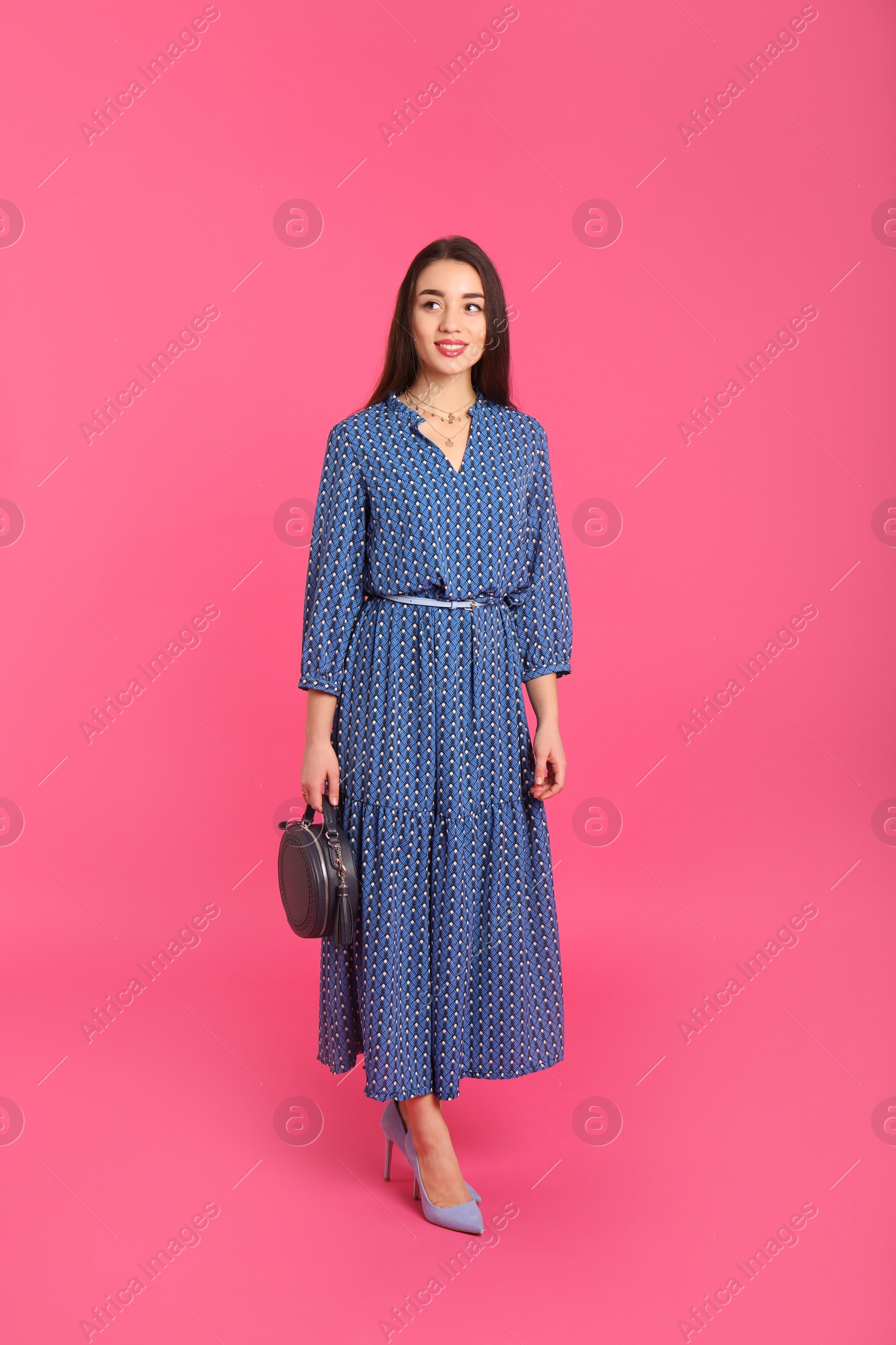 Photo of Portrait of beautiful young woman in stylish dress on color background