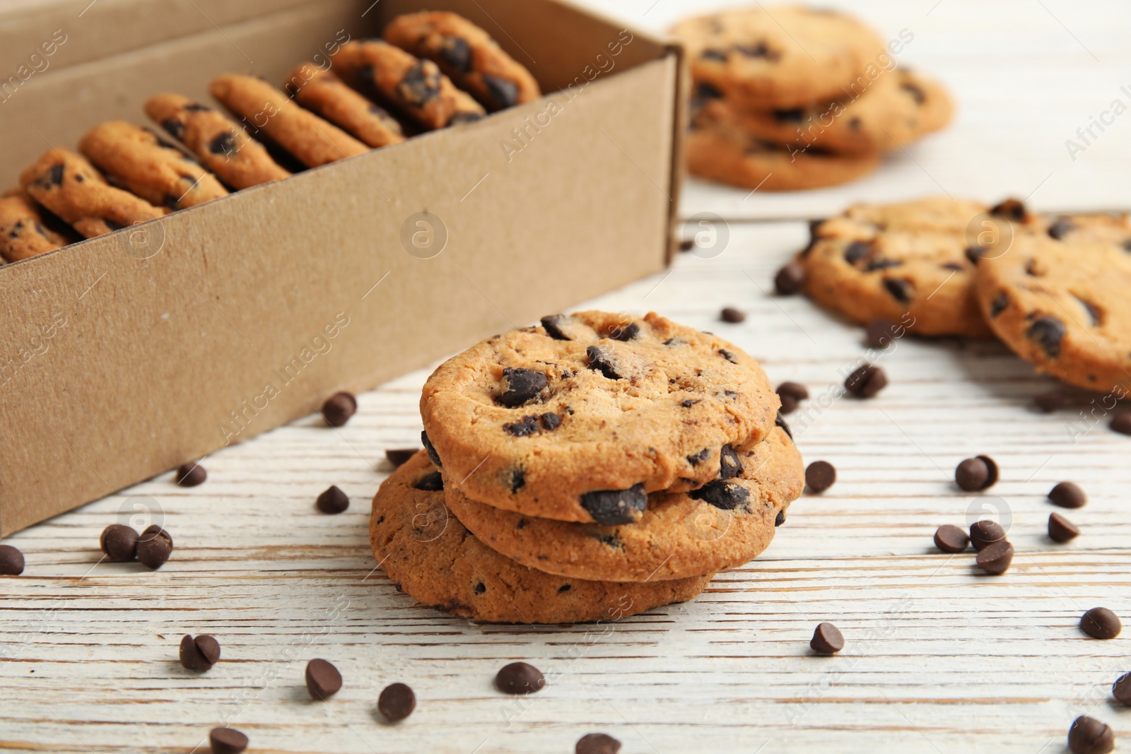 Photo of Delicious chocolate chip cookies on wooden table