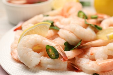 Photo of Tasty boiled shrimps with chili and parsley on table, closeup