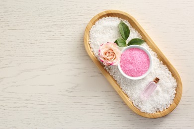Photo of Aromatic sea salt and beautiful flower on white wooden table, top view. Space for text