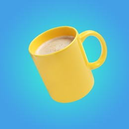 Image of Yellow cup of coffee drink levitating on light blue background