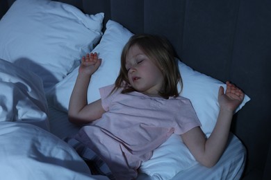 Photo of Little girl snoring while sleeping in bed at home