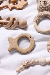 Photo of Many different baby accessories on white fabric