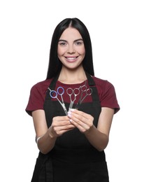 Photo of Portrait of happy hairdresser with professional scissors on white background