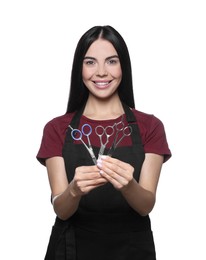 Portrait of happy hairdresser with professional scissors on white background