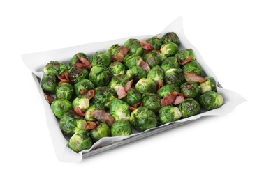 Photo of Delicious roasted Brussels sprouts and bacon in baking dish isolated on white