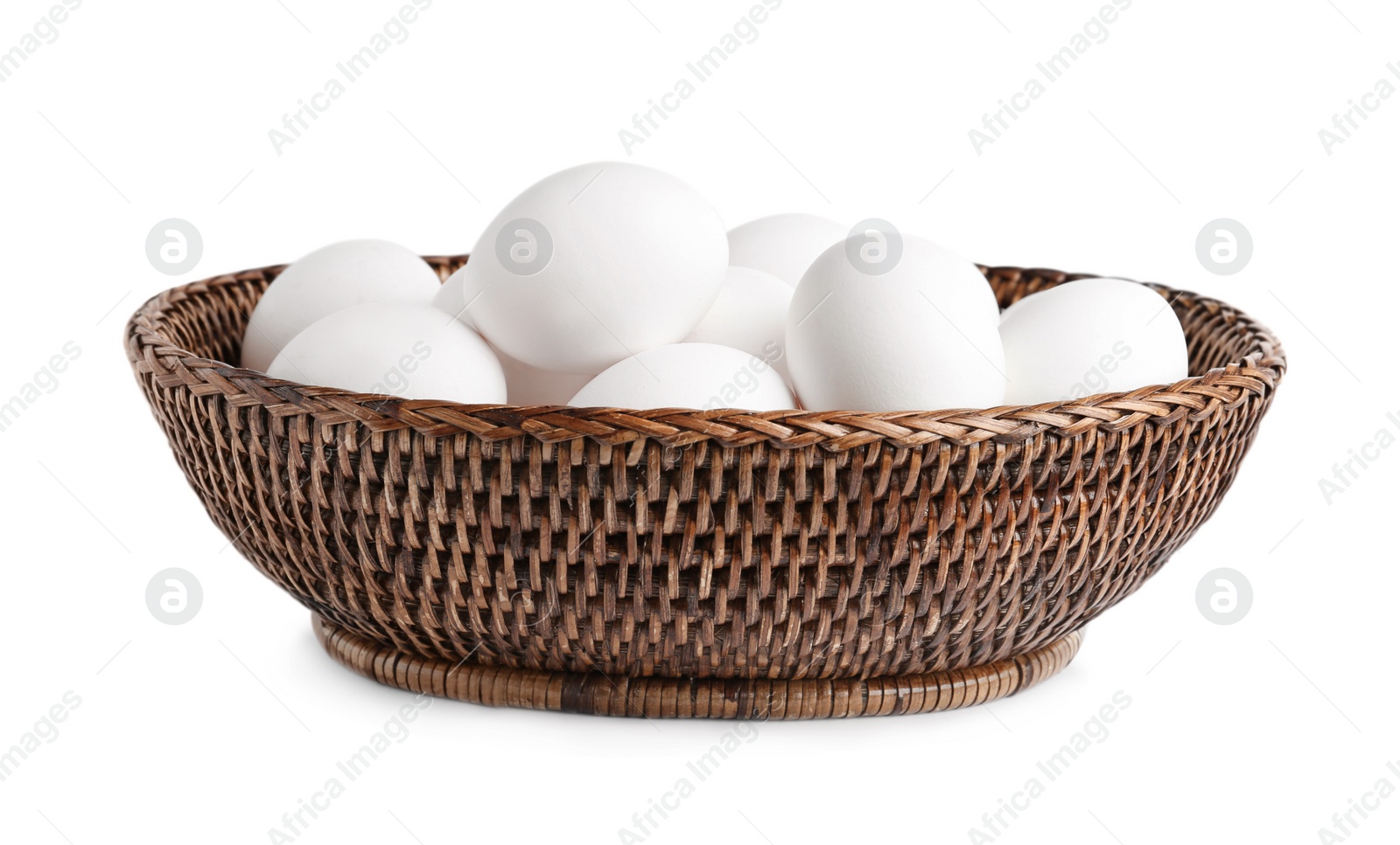 Photo of Chicken eggs in wicker bowl isolated on white