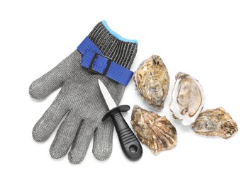 Photo of Fresh raw oysters, knife and chainmail glove on white background, top view