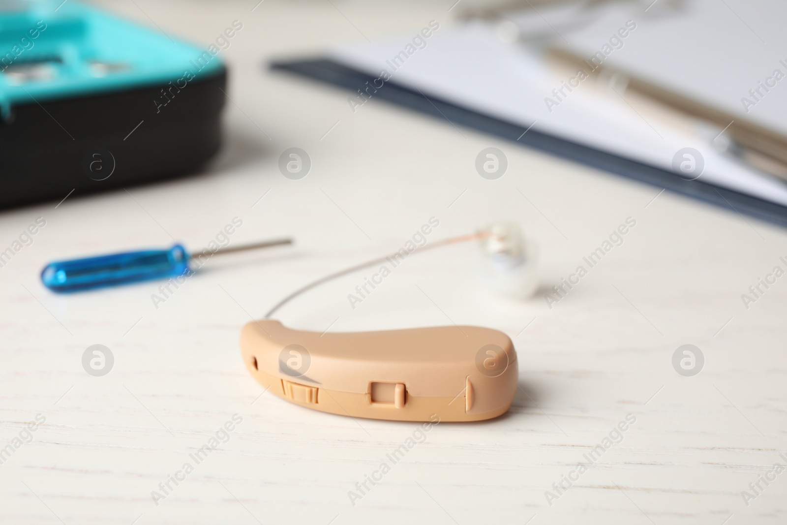 Photo of Hearing aid on white table. Medical device