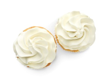 Photo of Tasty vanilla cupcakes with cream isolated on white, top view