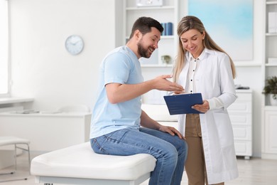 Photo of Professional doctor working with patient in hospital, space for text