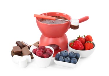 Photo of Fondue pot with melted chocolate, fresh berries, marshmallows and fork isolated on white